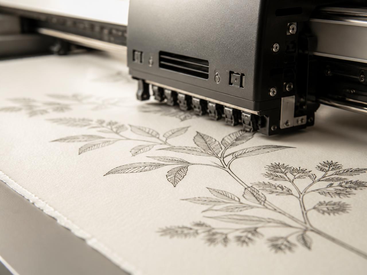 Macro view of a giclée print head laying pigment ink onto cotton rag paper
